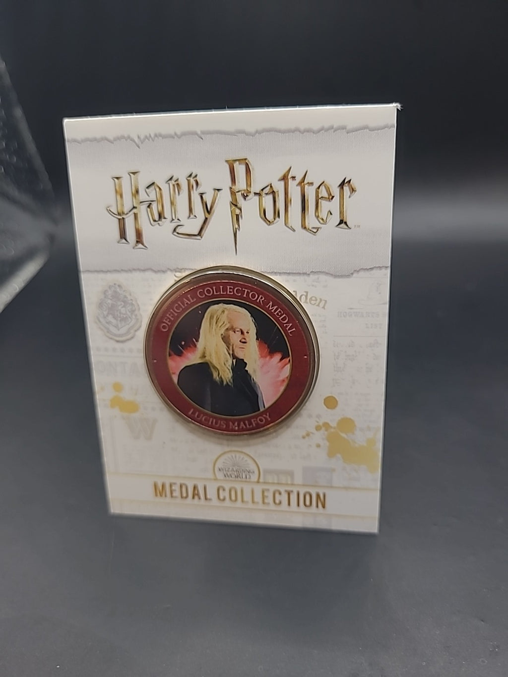 S6) RARE HARRY POTTER MEDAL COIN IN CARD LUCIUS MALFOY  JASON ISAACS JK ROWLING