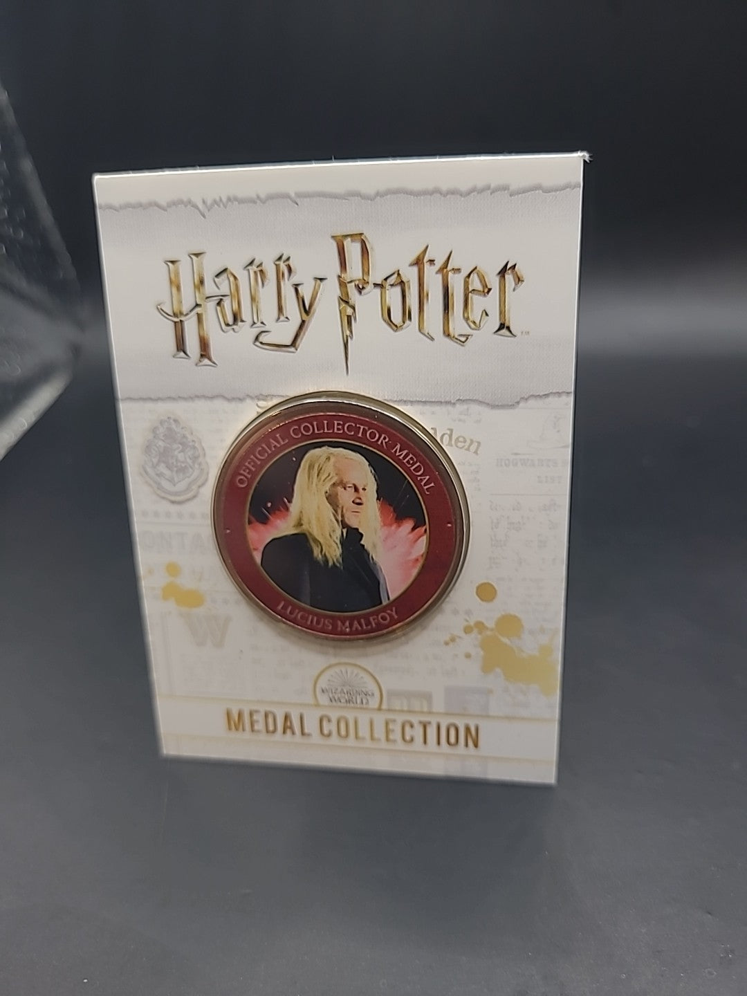 S6) RARE HARRY POTTER MEDAL COIN IN CARD LUCIUS MALFOY  JASON ISAACS JK ROWLING